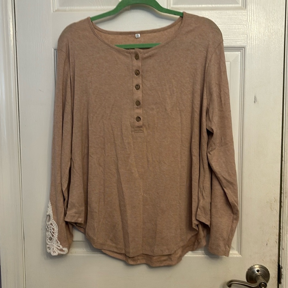 Tan, button up , long sleeve tee, with lace detail on the arms.